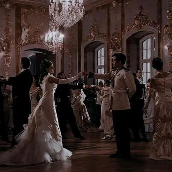 focuses on an open book being held by the passenger of a train. in the background, a rainy scene can be seen racing passedl